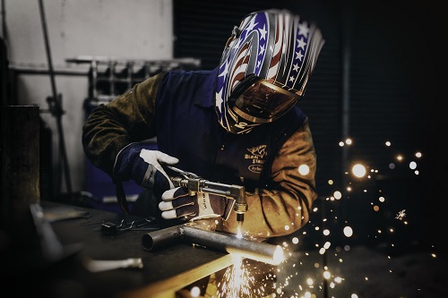 a man working on some iron tools to display how to make your skills in interview stand out in a job interview