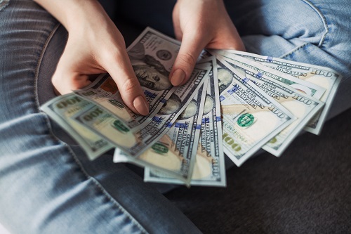Which Jobs Require Communication Skills? 1 hands holding American dollars bills to show which Jobs Require Communication Skills?