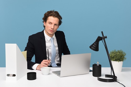 man sitting with laptop computer on desk and lamp to know which jobs require interpersonal skills