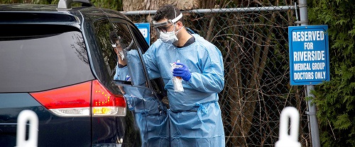 a man in blue beside a black care for treatment of coronavirus