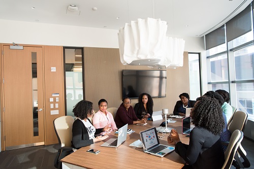 people sitting a table discussing types of communication skills