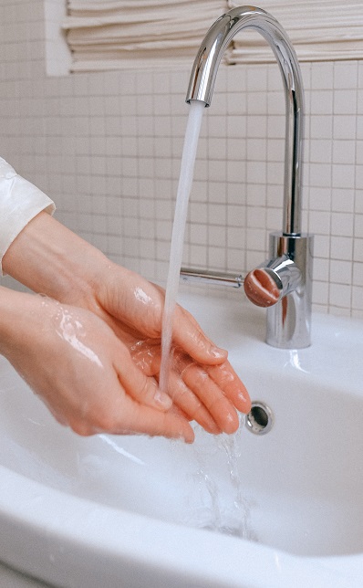 a person washing hands as the safety measures against coronavirus