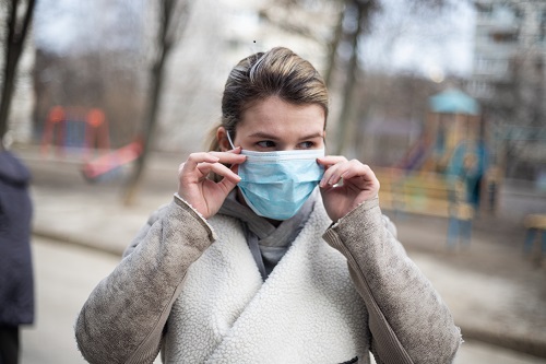 a woman wearing facemask as part of safety measures against Coronavirus 