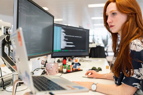 woman working on a computer exhibiting communication problems.