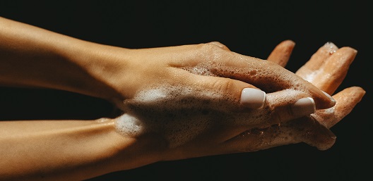 hands being washed to counter workplace safety hazards