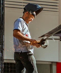 Top 7 Workplace Safety Hazards in the USA 1 worker cutting iron for workplace safety hazards