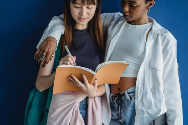 two girls discussing dialogue writing